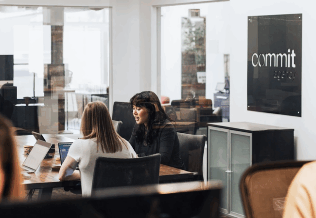 Two people are talking in a conference room